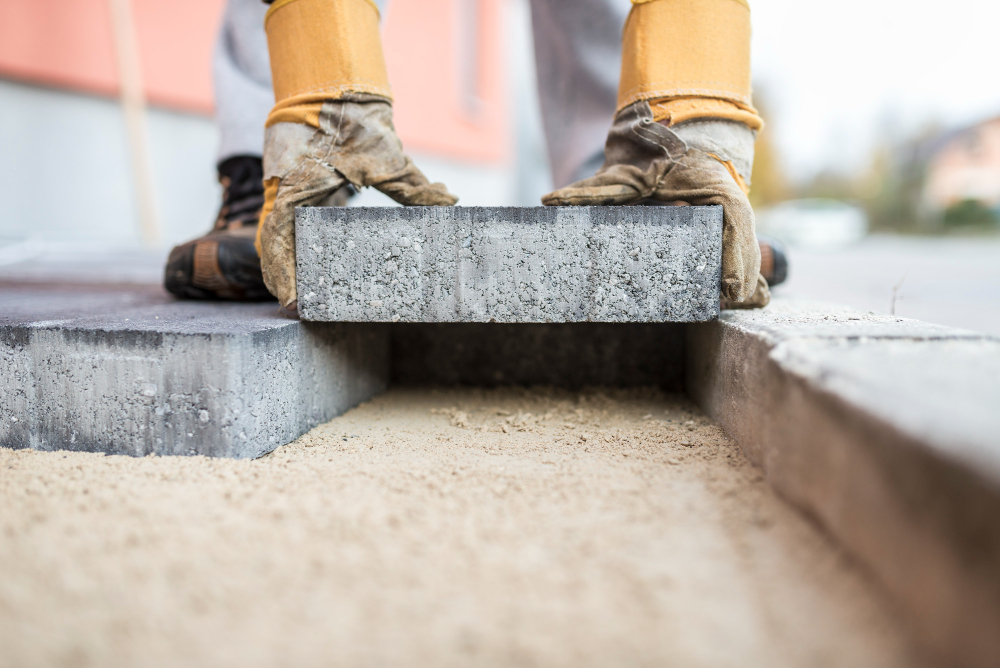 bricklaying construction worker building brick wall